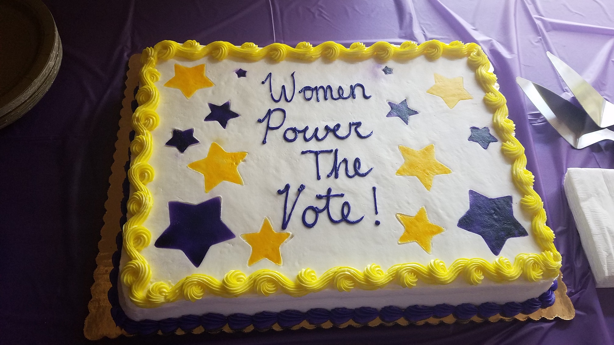 Decorated cake with message "Women Power the Vote!"