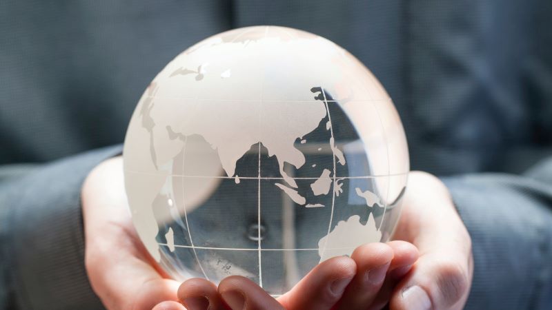 Photo of glass globe held in cupped hands
