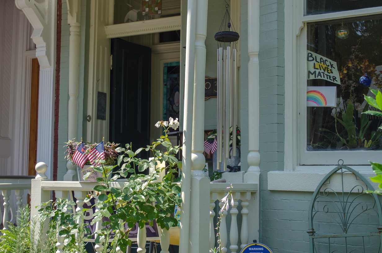 front of house with Black Lives Matter and rainbow signs in window