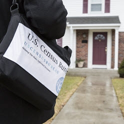 Census 2020 Census taker standing in front of house, ready to go in