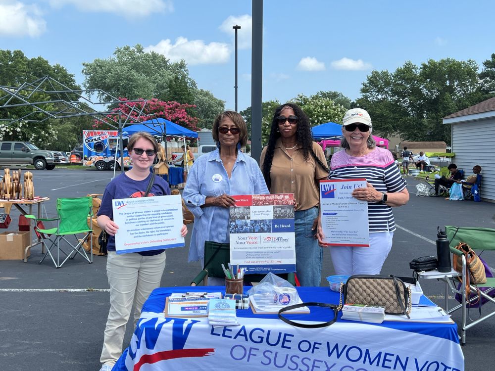 Photo of Sussex LWV members at Impact festival table