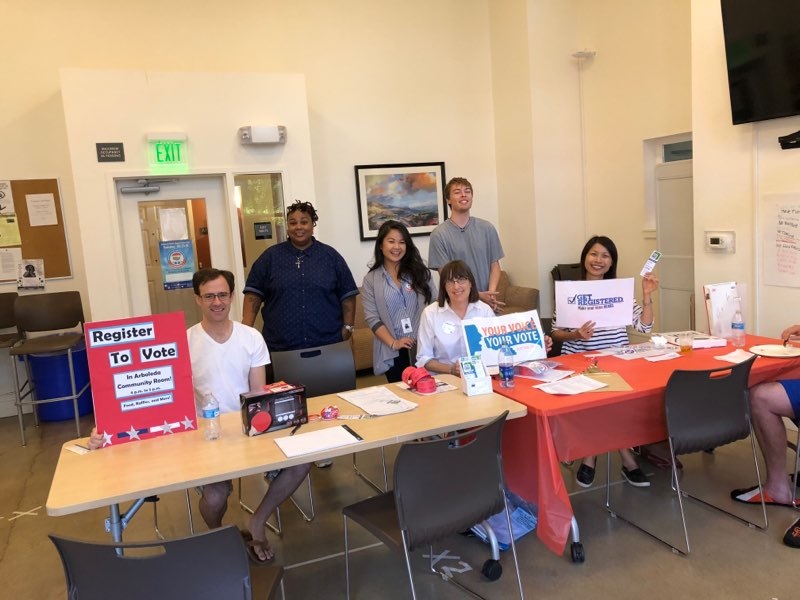 League helps register voters at affordable housing complex volunteers at table to help register voters