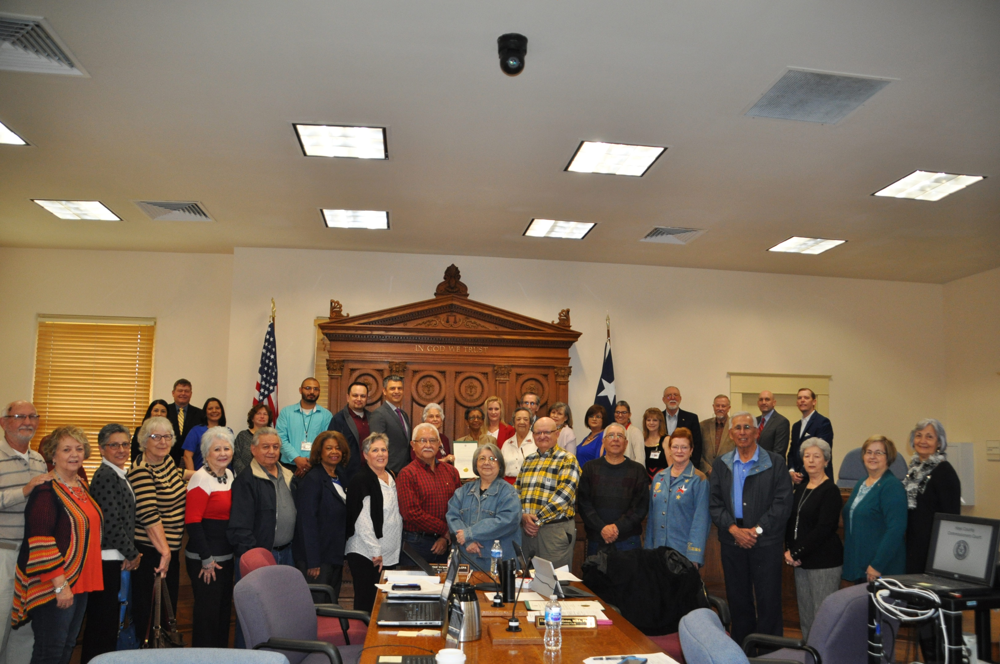 The Hays County Commissioners Court proclaimed March as Election Worker Appreciation Month, and staff and volunteer election workers showed up to help celebrate. Holding the proclamation are longtime election workers Jo Burdette and Mary Salinas. photo-Hays County Commissioners recognize election judges, clerks, and poll-workers