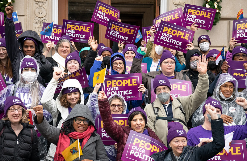 Group of protestors with People over Politics signs