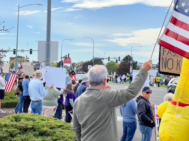People holding American flags at a protest.