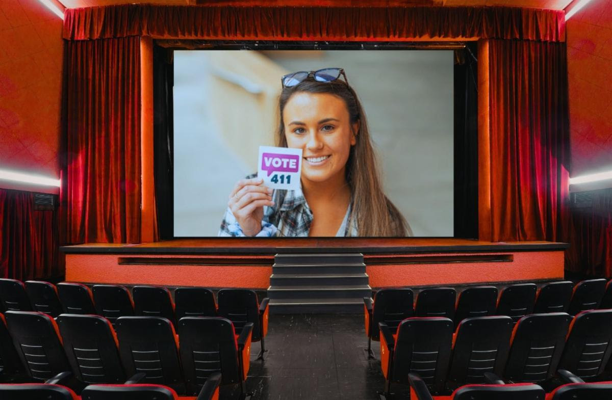 Girl with vote sticker on a movie screen