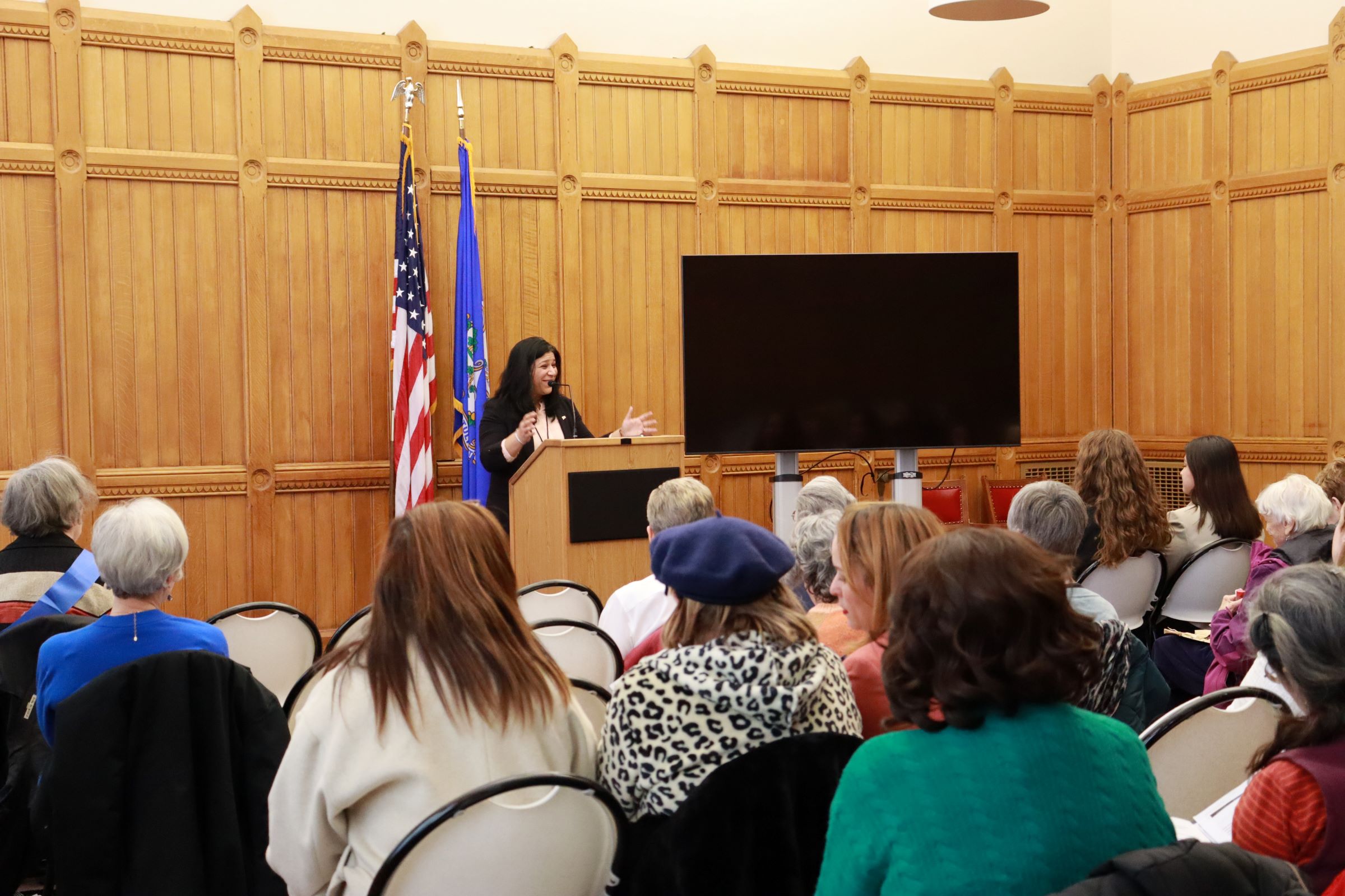 Image of LWVCT Advocacy Day picturing audience listening to Sujata Gadkar Wilcox speak at the podium.