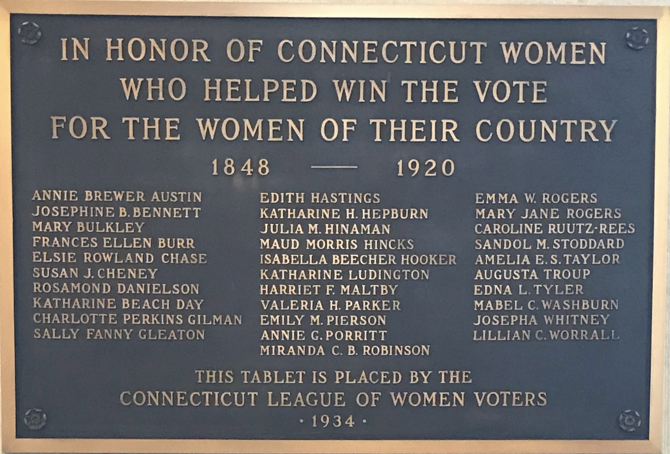 Black and gold plaque commemorating some of Connecticut's women suffragists.