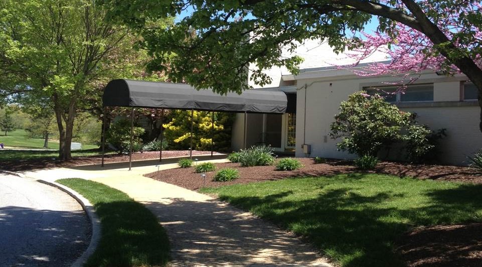 Entrance of the Ed Oliver Golf Course Clubhouse, with its signature black awning