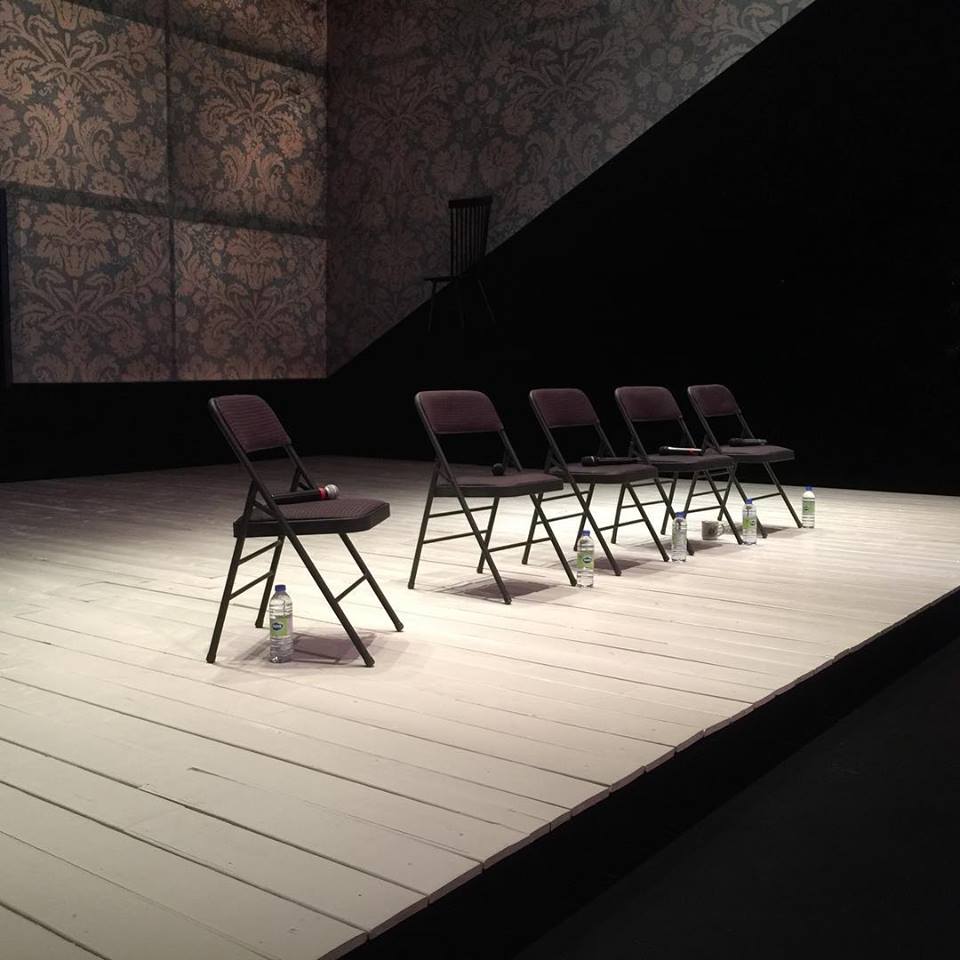 empty folding chairs on stage