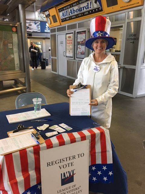 Registering voters at BART in October 2016 League member in Uncle Sam hat registering voters at BART
