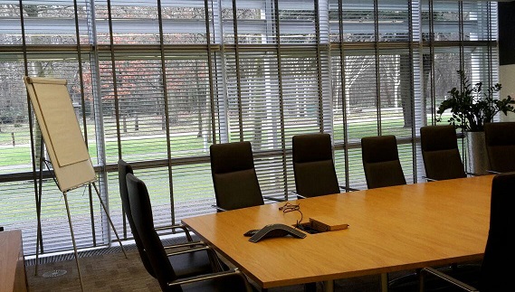 generic meeting room with tables, chairs, easel