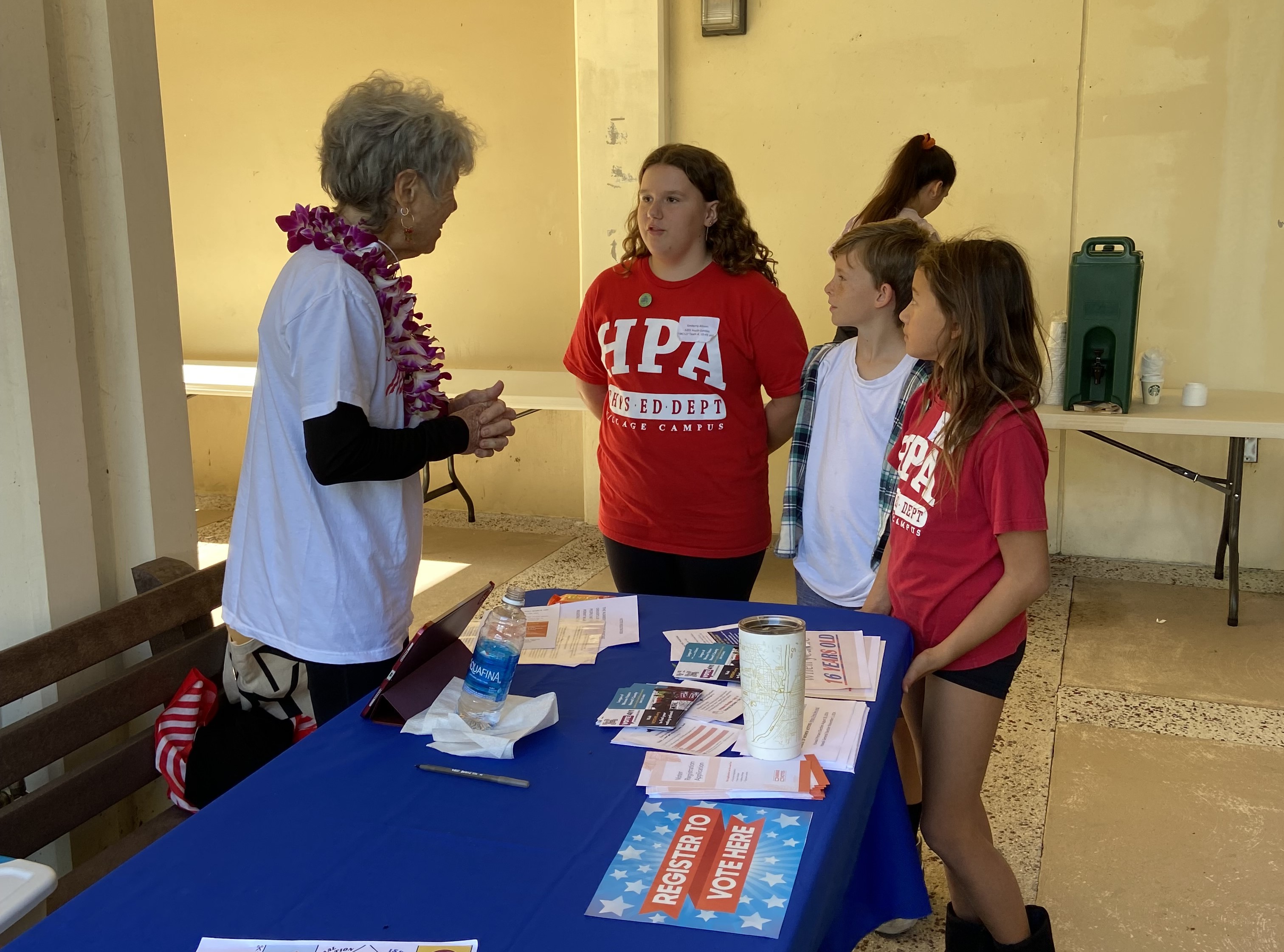 LWV Hawai'i County volunteer Nina Buchanan talks with youth at Hawai'i History Day in Hilo.
