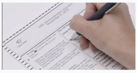 election ballot with hand marking the ballot with a pen