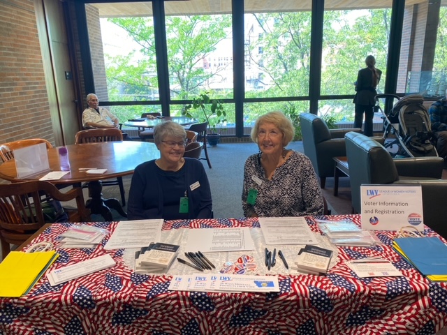 Picture of two league members at a table during the naturalization ceremony 