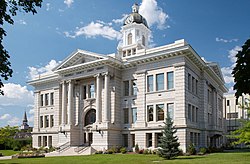 Photograph of Missoula County courthouse, it is a large white stone building with columns out front.