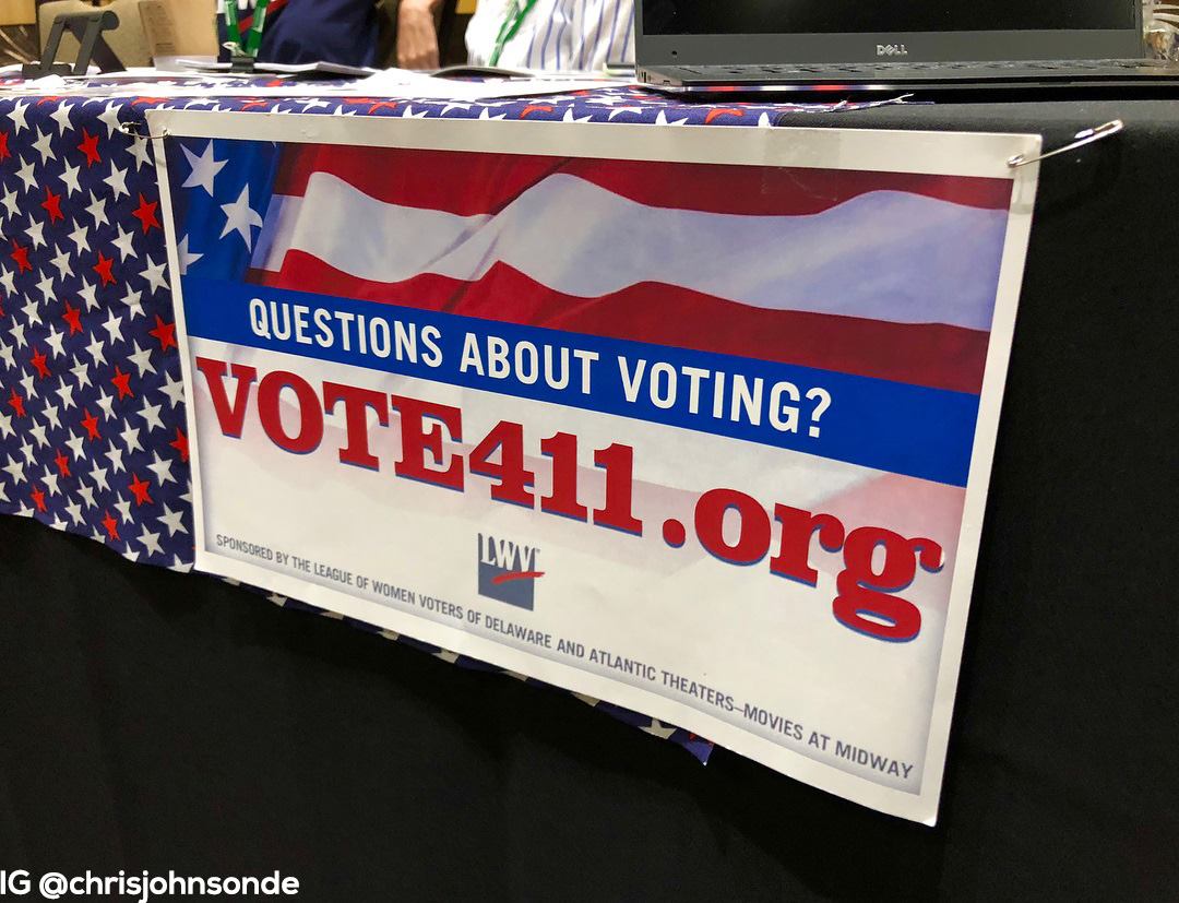 Poster with flag design reading "QUESTIONS ABOUT VOTING? VOTE411.org"