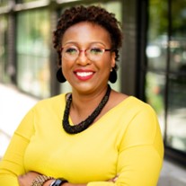 African American Woman with arms crossed, yellow top