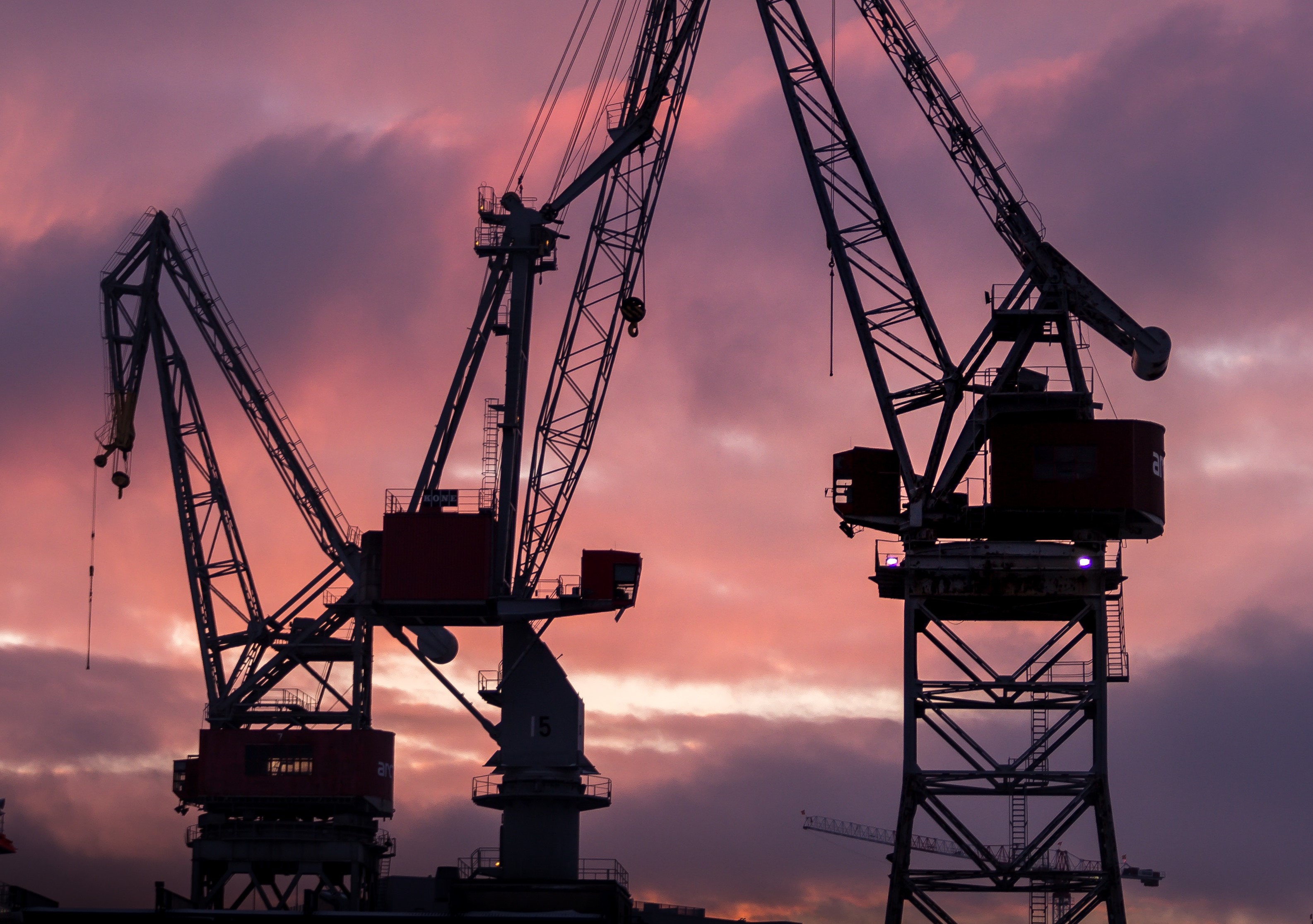 silhouette of construction cranes