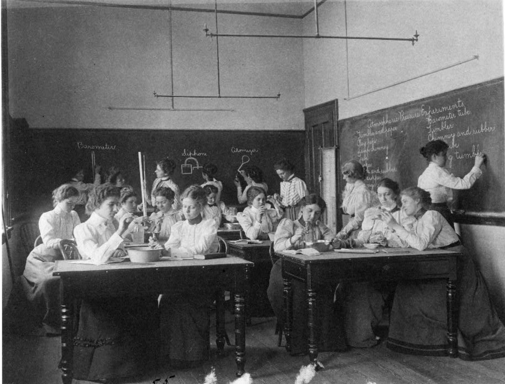 women performing atmospheric pressure experiments 