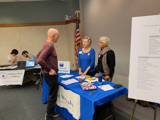 LWVW members Ellie Perkins and Marguerite Chatelier signing up new member, Peter Marx