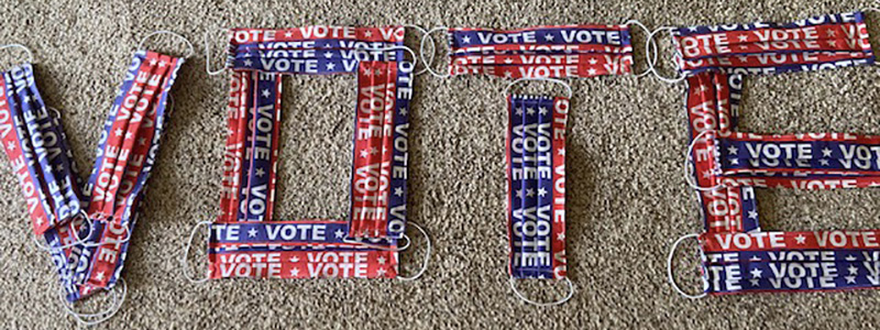 VOTE spelled with masks VOTE spelled with masks