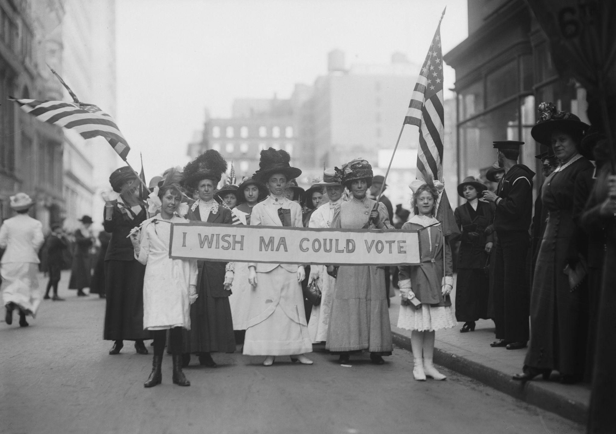 Suffragettes holding sign "I wish Ma could vote."