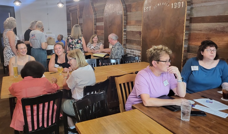 New Members Gather with Leaders to Learn More About the League New members and leaders at tables at Schafly Bottleworks