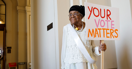 Woman Holding Sign Your Vote Matters