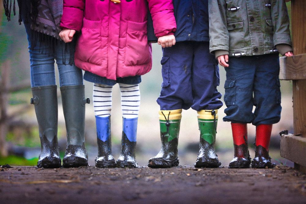 Photo by Ben Wicks on Unsplash four children standing on dirt during daytime