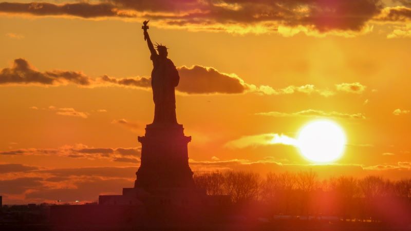 Photo by Rehan Syed on Unsplash Statue of Liberty silhouetted against an orange sunset