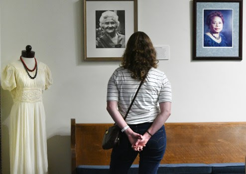 Caitlin McSherry reads about important women in Vallejo's history like Elsa Widenmann and Grace Patterson. The display pieces are part of a new exhibit at the Vallejo Naval and Historical Museum featuring the Votes For Women poster display from the Smithsonian. (Chris Riley—Times-Herald)