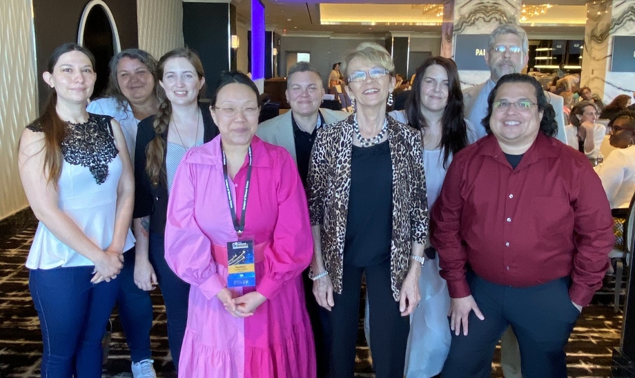 Board members of the League of Women Voters of Nevada stand together, smiling indoors