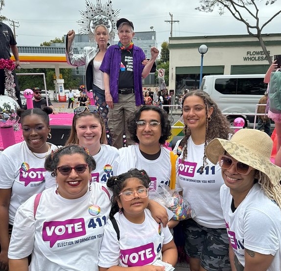 League members in VOTE411 shirts pose at the Pride Parade with Cyndi and Ellen Lauper