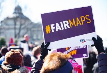 Crowd of protesters holding LWVUS #FAIRMAPS signs