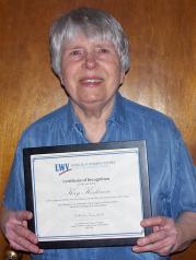 Kay Keskinen holding lifetime membership certificate