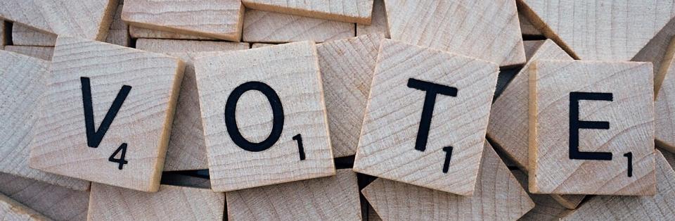 Scrabble tiles spell out the word vote