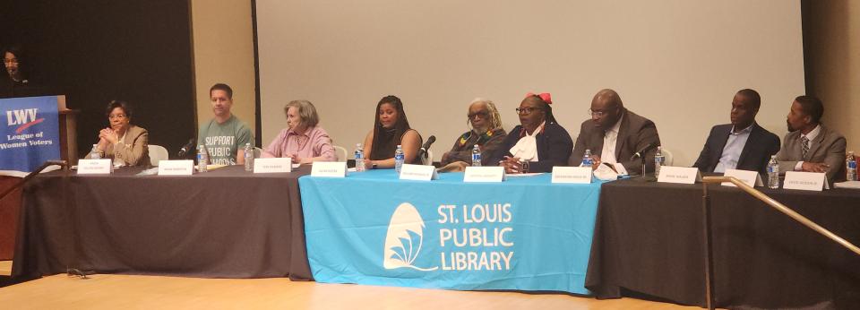 Candidate Forum in St. Louis City Candidates sitting at table with moderator standing at left