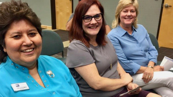 League members study issues Three women smiling