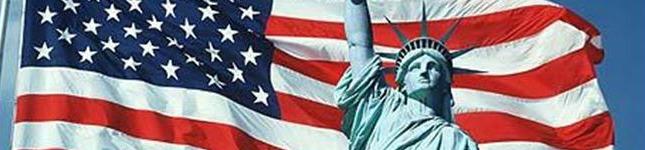 Header image of Statue of Liberty in front of waving USA flag