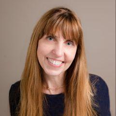 Headshot of Elizabeth Hamilton, executive editor of the CT Mirror in a navy blue shirt