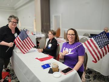 LWV-VA Members waving the USA flag at the 2025 convention.