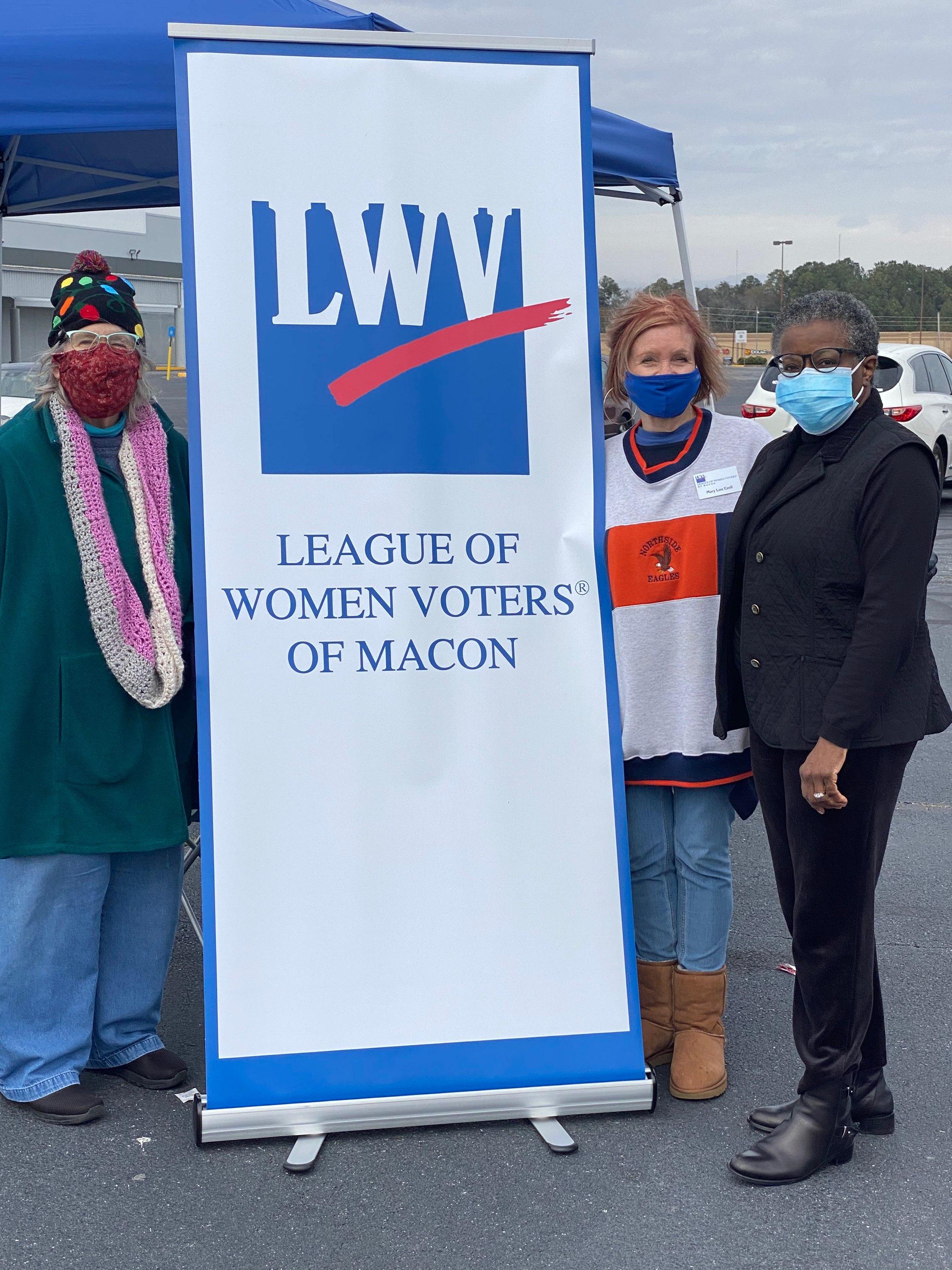 Harriet Jardine, Mary Lou Ezell and Mildred Henderson in front of  LWV sign