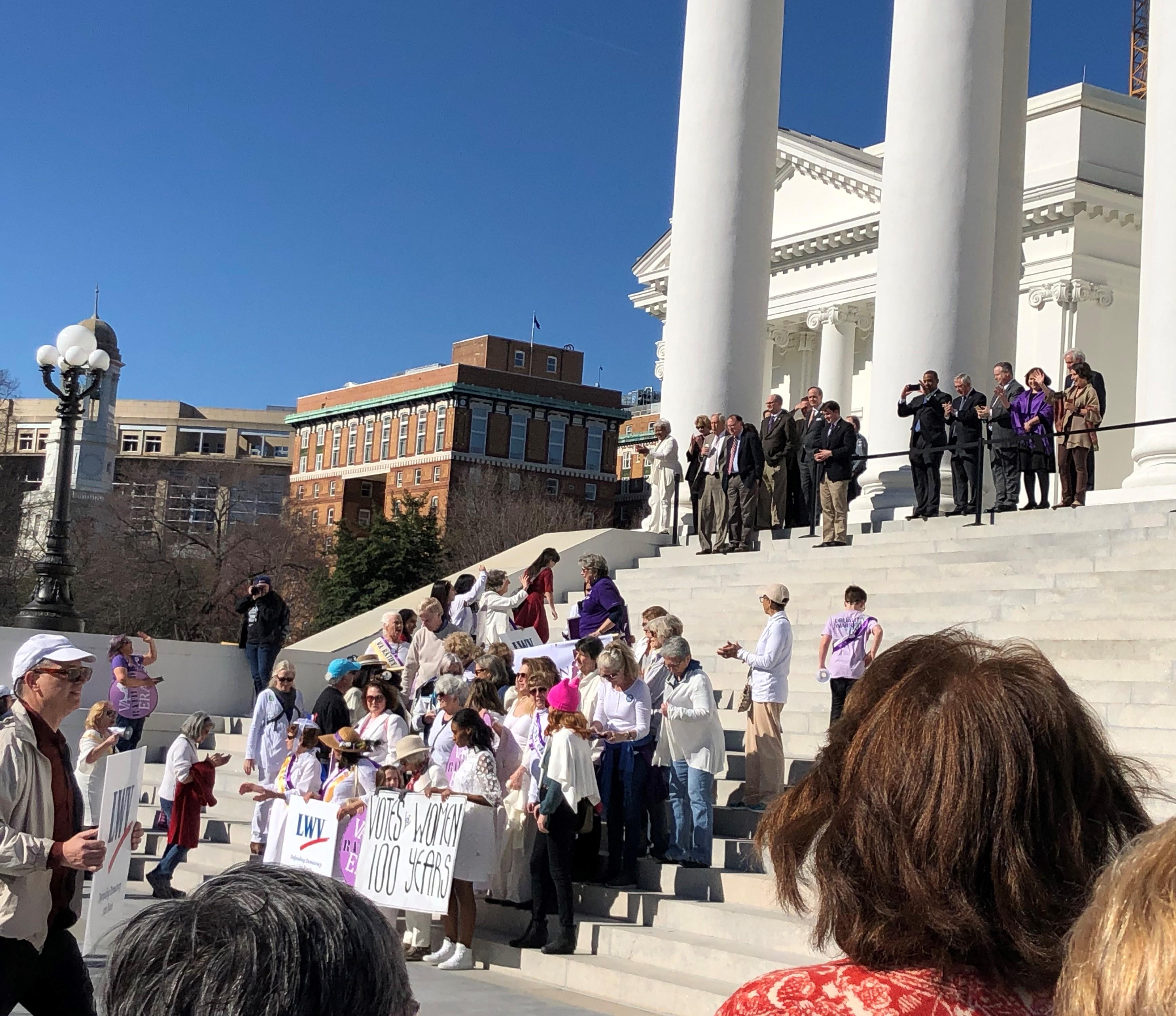 Picture of women on steps of Capitol in Richmond VA with signs for ERA & LWV 100 years