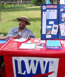 Woman seen manning an LWV voter registration table