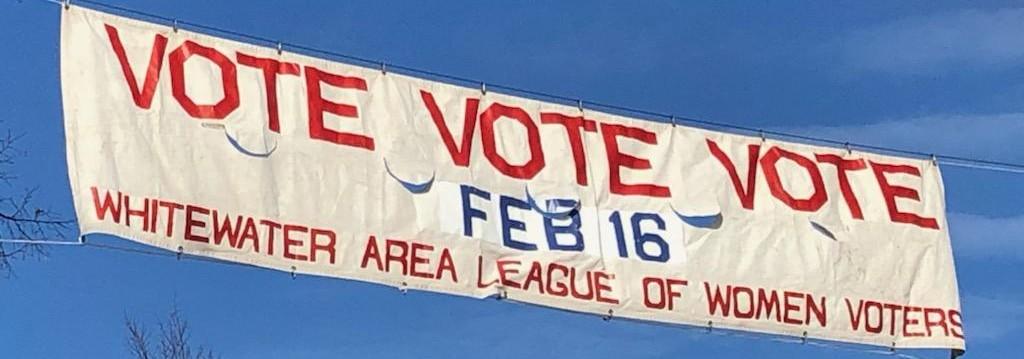 Street banner reading "VOTE VOTE VOTE"