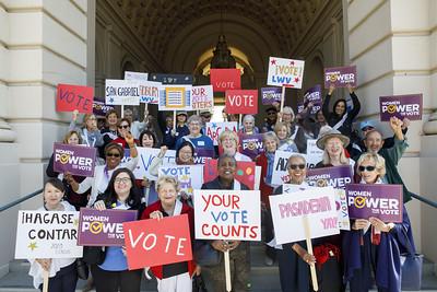 group photo of The League of Women Voters get out the vote and census march at City Hall on Friday, February 14, 2020 in Pasadena, Calif.  people are holding signs that state "vote" , "women power the vote" , "your vote counts", "your vote matters"