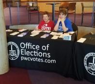 Leaguers at voter registration table at Naturalization Ceremony