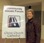 League member with sign: "Community Issues Forum - Christ Church Cathedral"