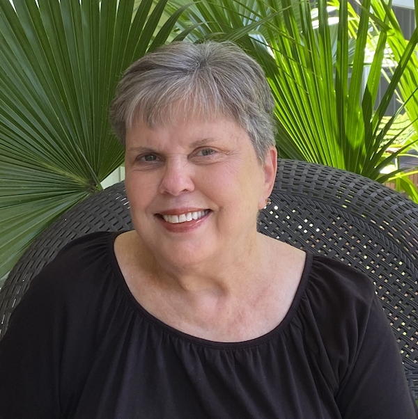 Woman with short gray hair and black top